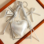Load image into Gallery viewer, Silver PU Heart Bow Rope Bag Charm Keychain Luxe S5P932