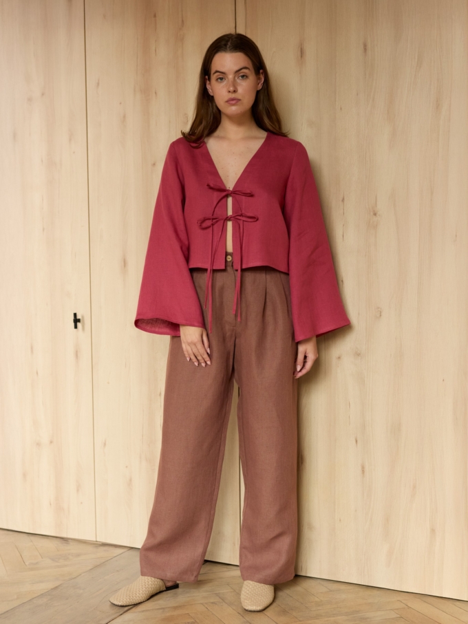 Image 3 of CASSIDY cropped linen top in Raspberry, featuring a tie-front closure, deep V-neck, and long bell sleeves, from ALBERALKIRK.