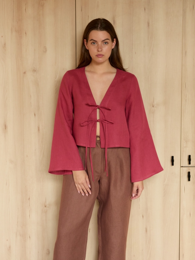 Image 2 of CASSIDY cropped linen top in Raspberry, featuring a tie-front closure, deep V-neck, and long bell sleeves, from ALBERALKIRK.