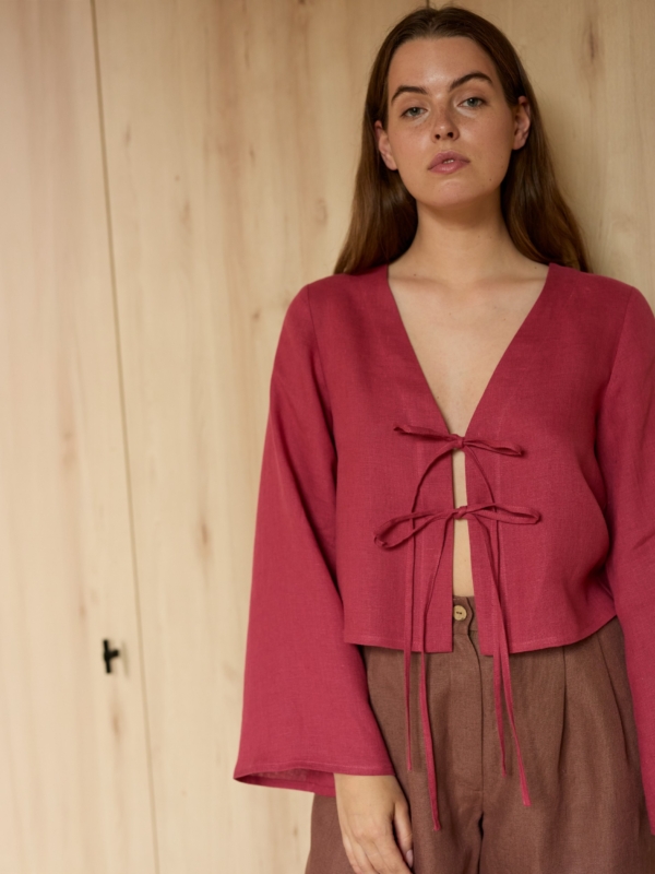 Image 1 of CASSIDY cropped linen top in Raspberry, featuring a tie-front closure, deep V-neck, and long bell sleeves, from ALBERALKIRK.
